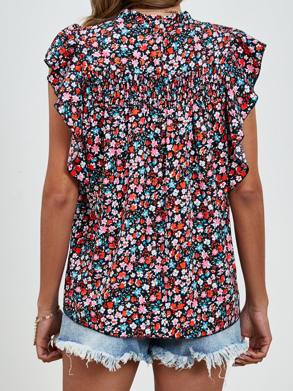 Black floral blouse with smocked yoke and ruffle sleeves