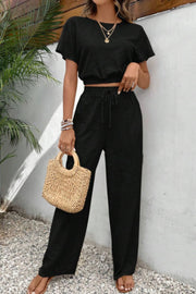 Black textured crop top and wide-leg trousers with drawstring waist