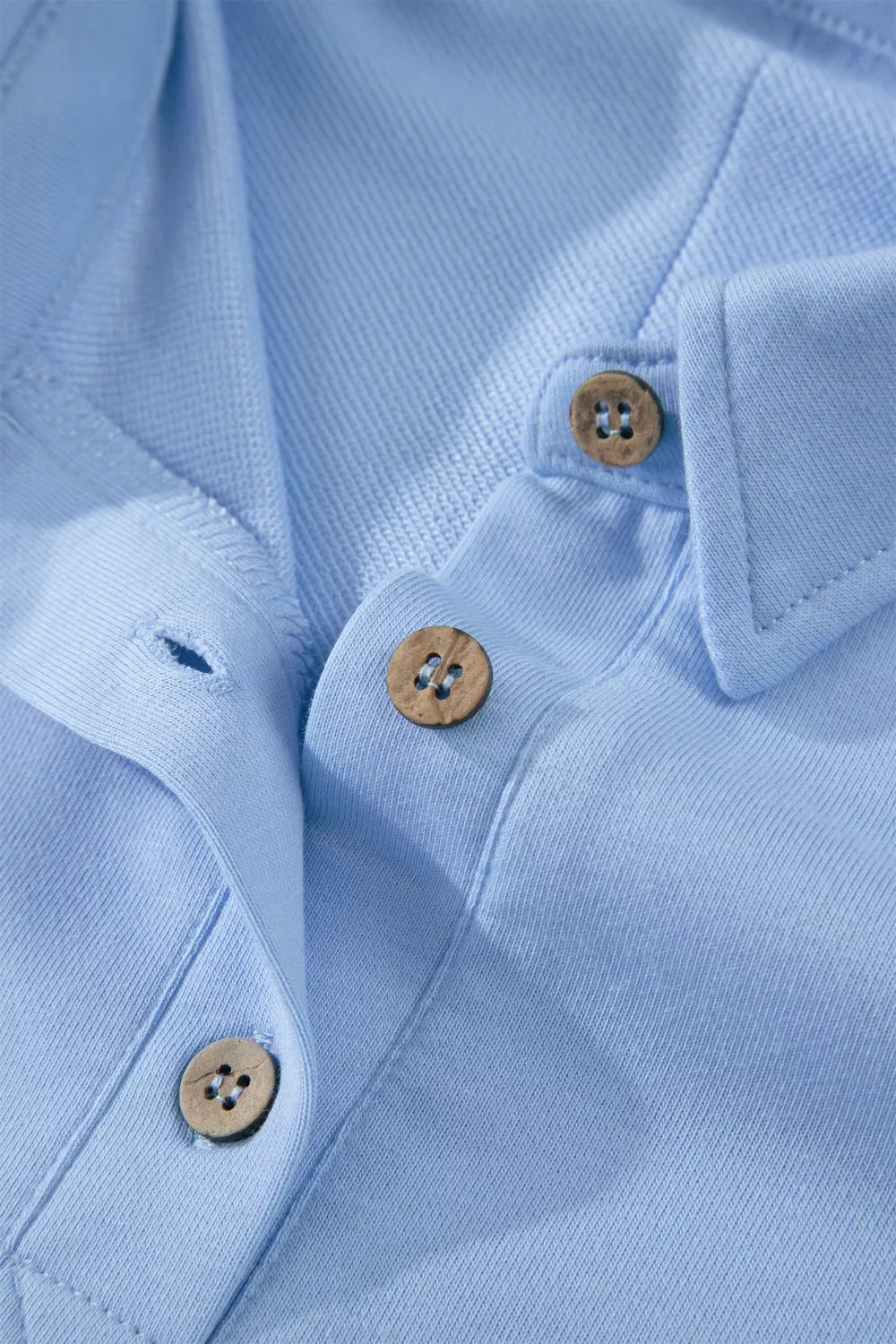 Light blue sleeveless polo top with button detail and collar