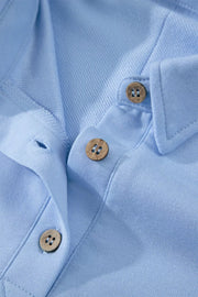 Light blue sleeveless polo top with button detail and collar