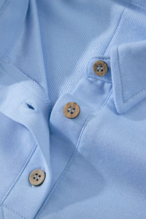 Light blue sleeveless polo top with button detail and collar