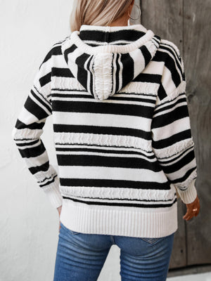 Black and white striped knit hoodie with textured details and ribbed cuffs.