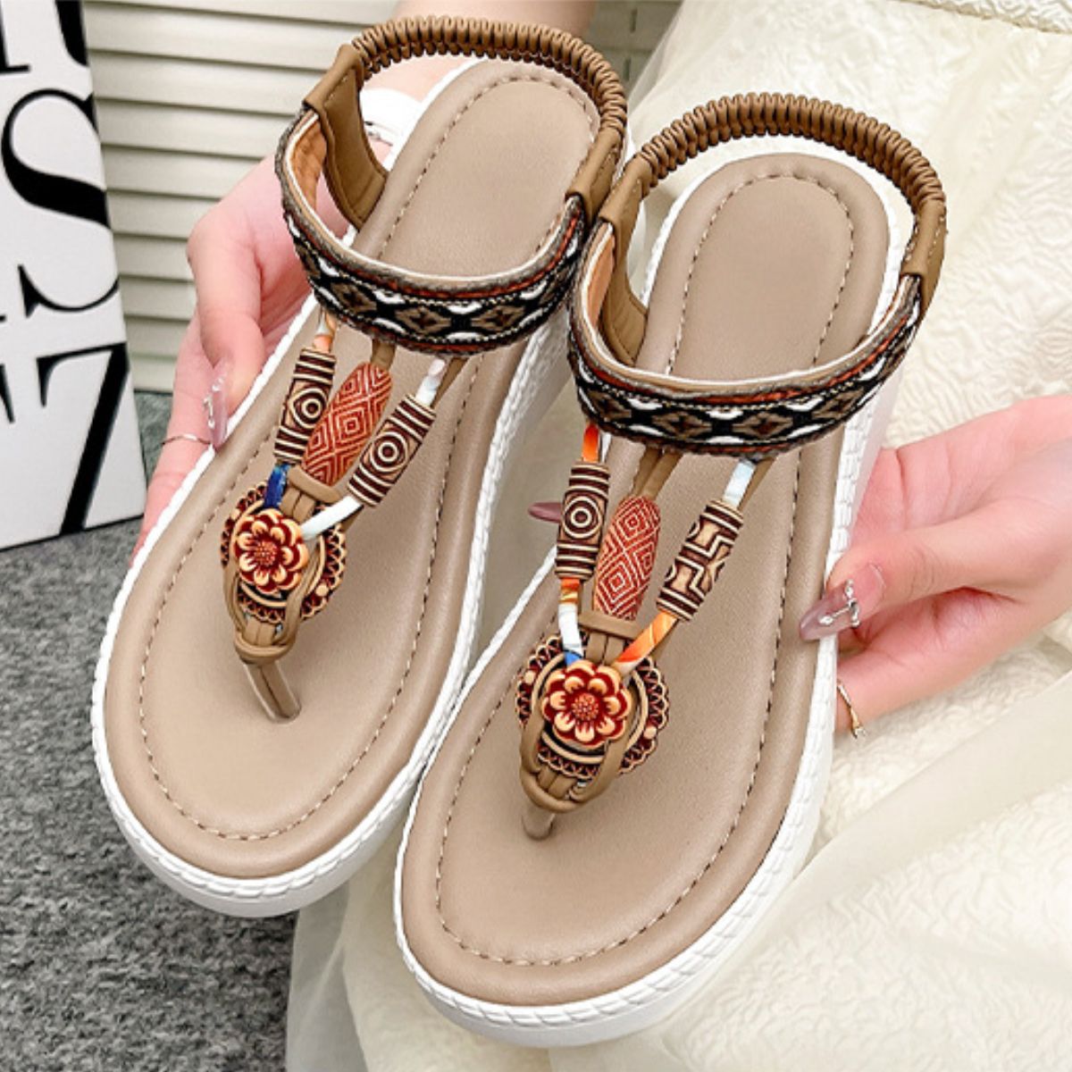 Ethnic-patterned wedge sandals in khaki with floral accents and beaded details.