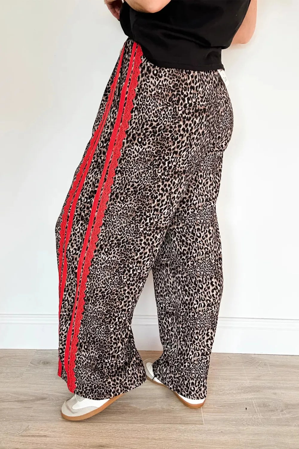 Maternity wide-leg pants in leopard print with red stripe detail and drawstring waist.