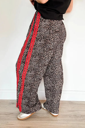 Maternity wide-leg pants in leopard print with red stripe detail and drawstring waist.