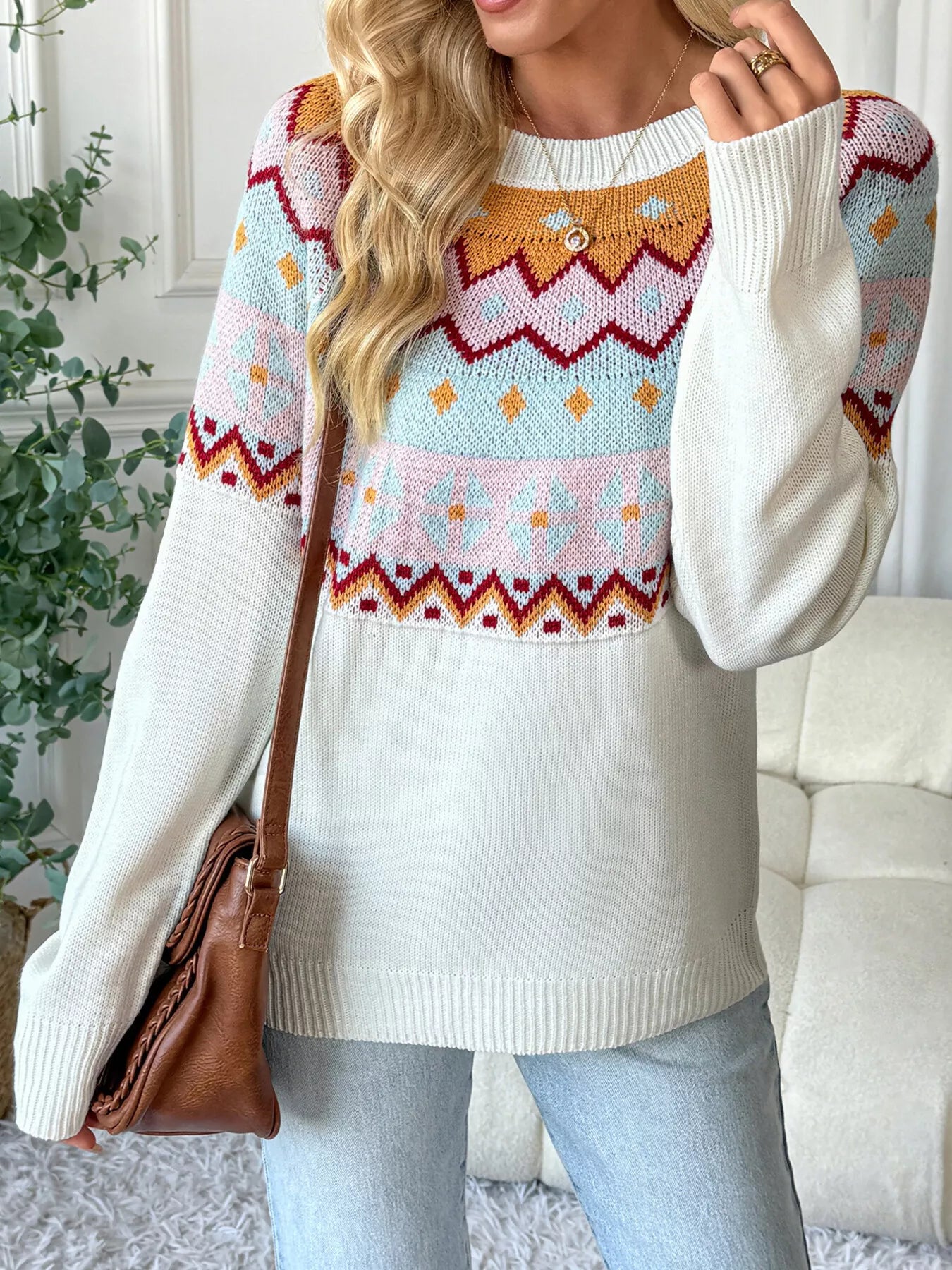 Geometric knit long-sleeve sweater in white with colorful fair isle pattern and crew neck.