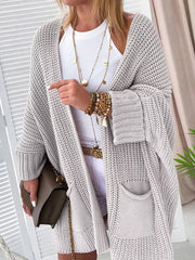 Cozy open front cardigan in light gray acrylic knit with pockets and a relaxed fit.