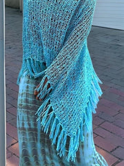 Sky blue open-knit acrylic poncho with fringe trim and boat neck.
