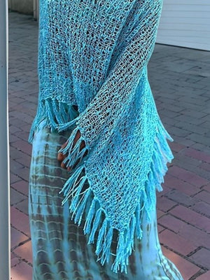 Sky blue open-knit acrylic poncho with fringe trim and boat neck.