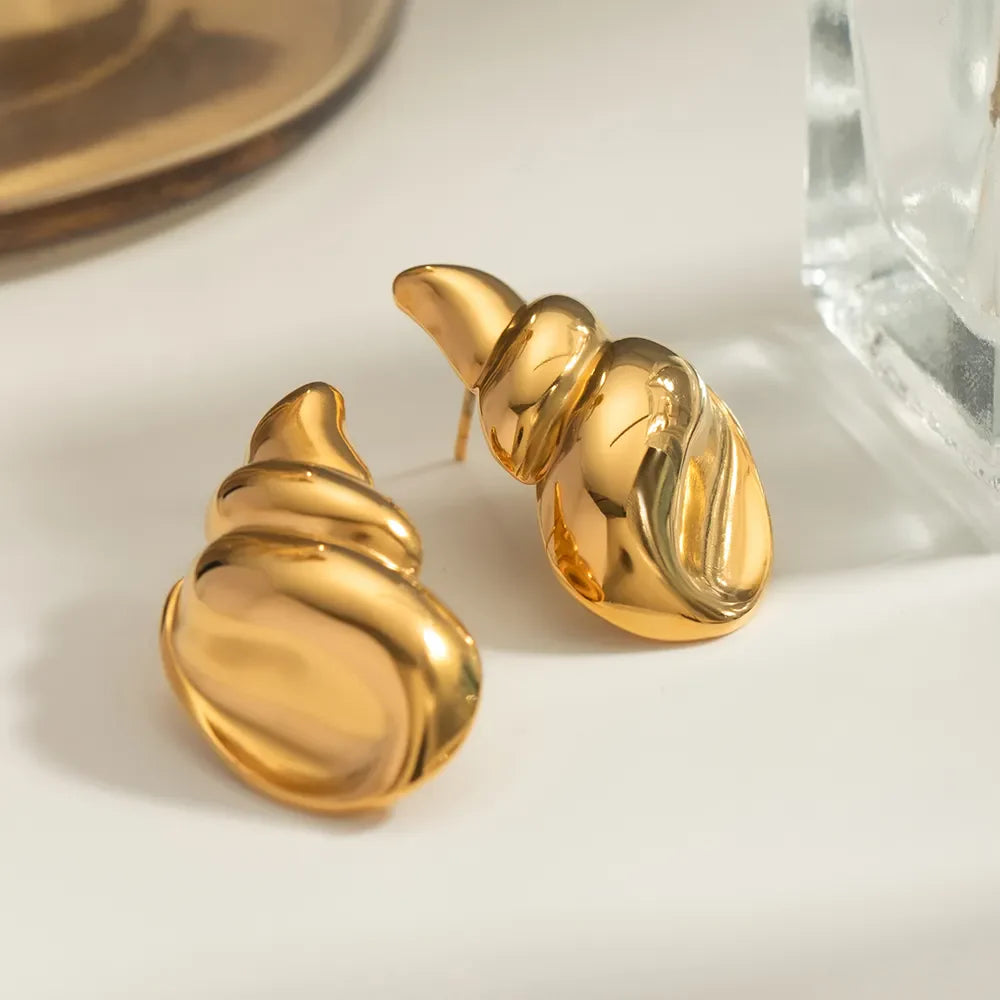 Gold sculptural seashell drop earrings with a polished finish.