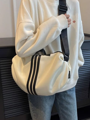 Medium off-white Oxford cloth crossbody bag with black stripe detail and adjustable strap.