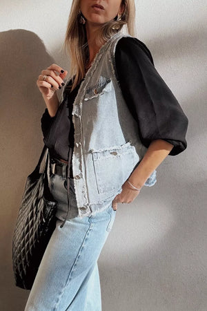Light wash denim vest with frayed edges and chest pockets, button-down front.