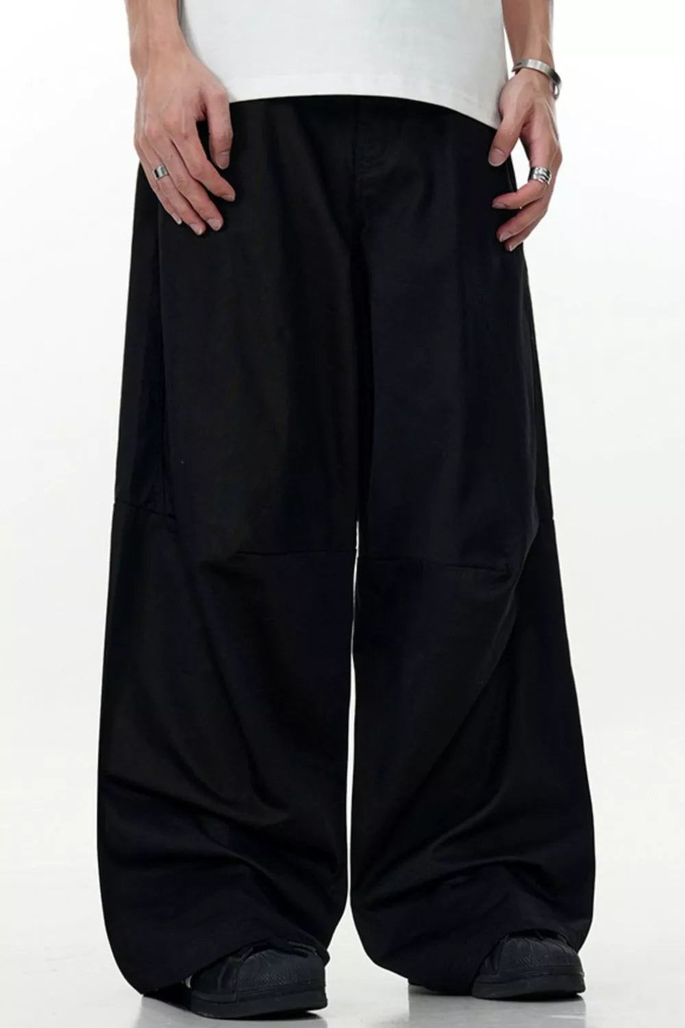Men's black wide leg cargo pants with a relaxed fit and full swing.