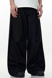 Men's black wide leg cargo pants with a relaxed fit and full swing.