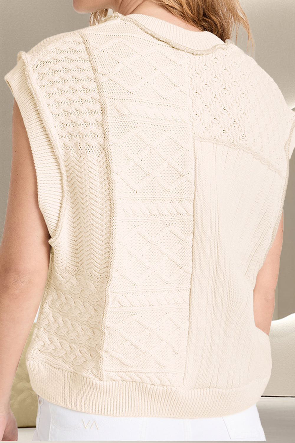 Ivory knit patchwork vest with varied cable knit textures and patterns.
