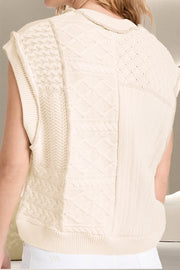 Ivory knit patchwork vest with varied cable knit textures and patterns.
