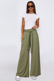 Moss wide-leg flow pants with self-tie waist, styled with a white tee.