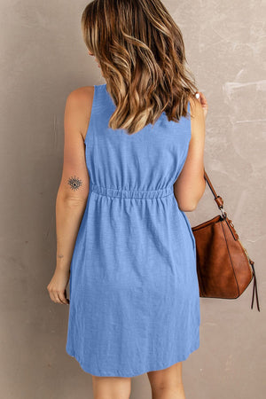 Blue button-down mini dress with gathered waistline and sleeveless cut