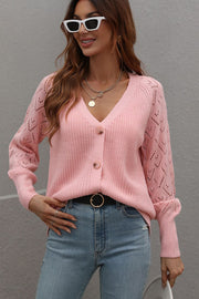 Pink diamond knit button-down cardigan with openwork sleeves and V-neck.