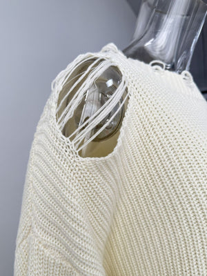 Off white distressed cotton sweater with deconstructed shoulder detail and frayed threads.