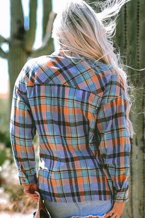 Oversized plaid shacket in orange and blue check, with button-down collar and long sleeves.
