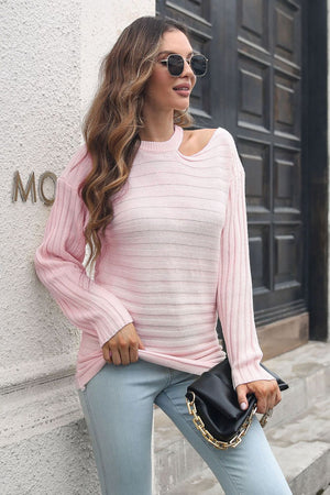 Blush pink ribbed knit sweater with asymmetric shoulder detail and horizontal stripe texture.