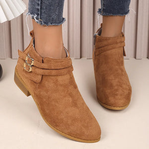 Ochre suede ankle booties with double buckle detail and side zipper.