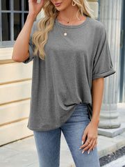 Gray relaxed fit crew neck t-shirt with cuffed short sleeves, styled with jeans.