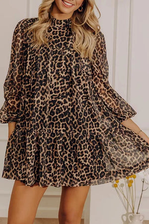 Chic leopard print tiered shift dress with mock neck and long sleeves.