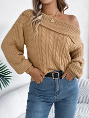 Tan cable knit off-shoulder sweater with textured neckline and sleeves.