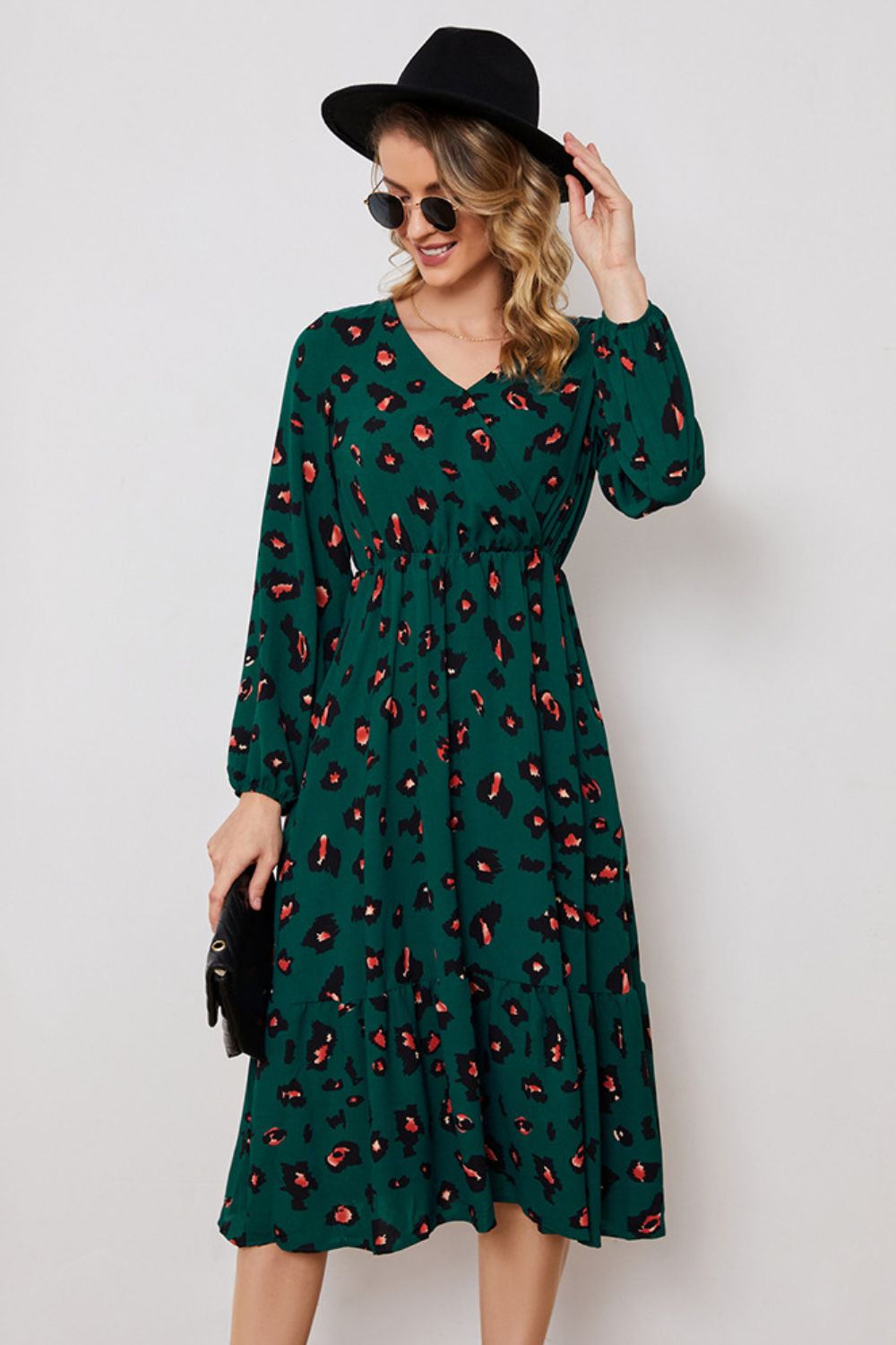 Emerald leopard print midi dress with balloon sleeves and a tiered hem.