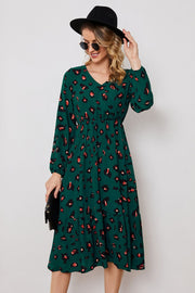 Emerald leopard print midi dress with balloon sleeves and a tiered hem.