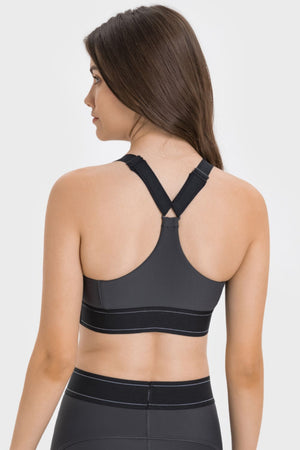Gray performance sports bra with crossback straps and black banded hem.