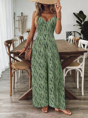 Matcha green wide-leg jumpsuit with black abstract print, V-neck, spaghetti straps, and smocked bodice.