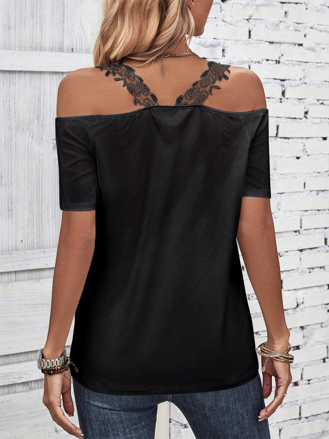 Black off-the-shoulder top with lace yoke detail and short sleeves.