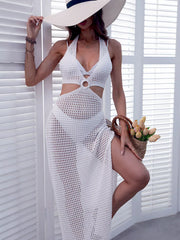 White halter neck crochet cover-up dress with ring detail and cutouts.