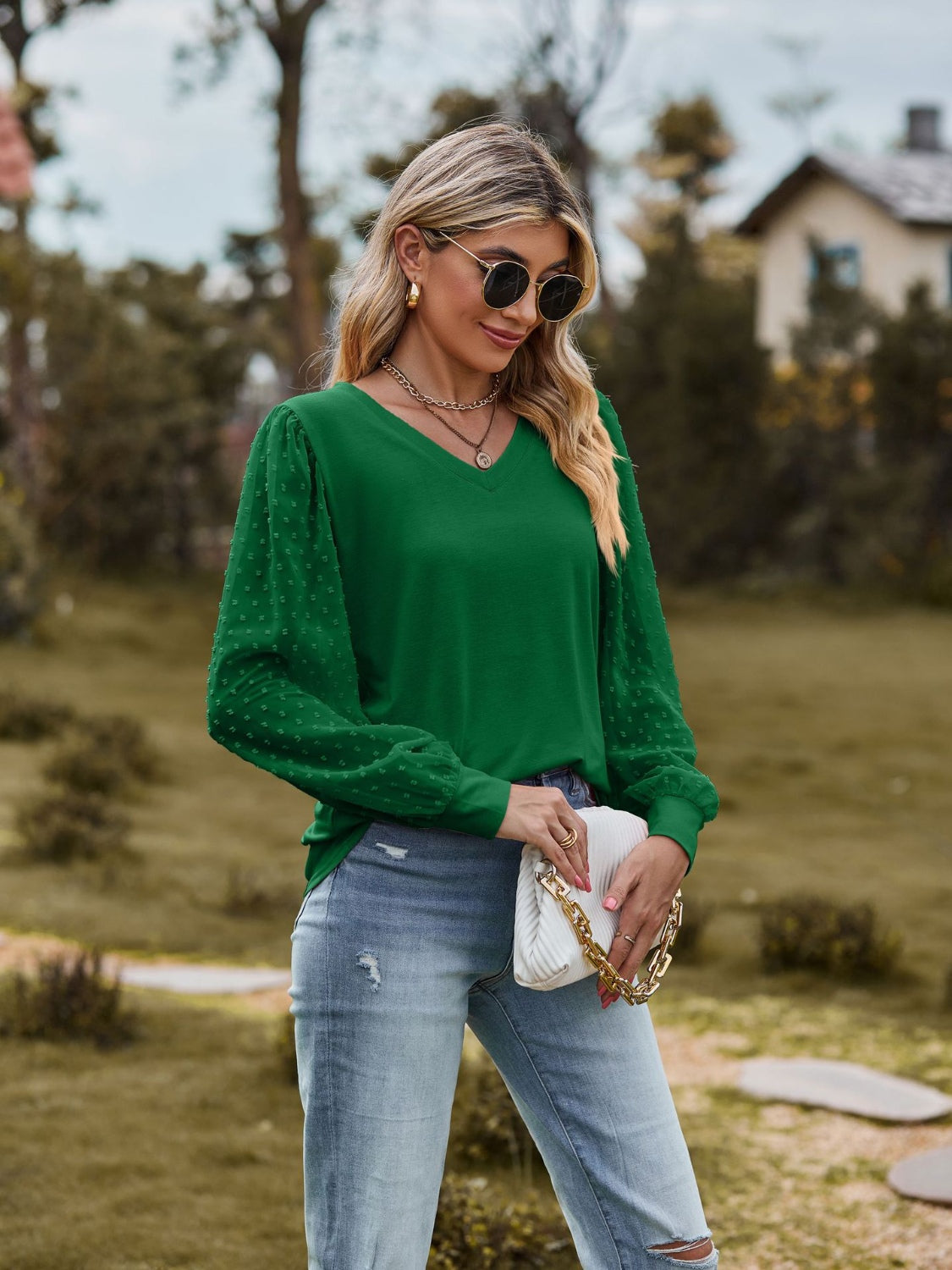 Green v-neck blouse with swiss dot puff sleeves and a relaxed fit