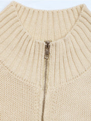 Ribbed knit zip-front vest in tan acrylic with a silver zipper detail.