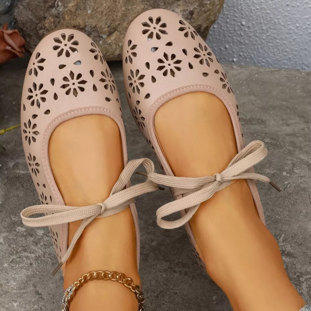 Apricot floral cutout slip-on flats with ankle ties and a gold chain anklet.