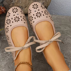 Apricot floral cutout slip-on flats with ankle ties and a gold chain anklet.