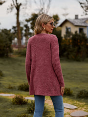 Longline ribbed knit button-down cardigan in rust, shown from the back.