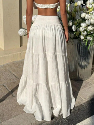 White smocked tiered maxi skirt with crinkled texture and airy fabric.