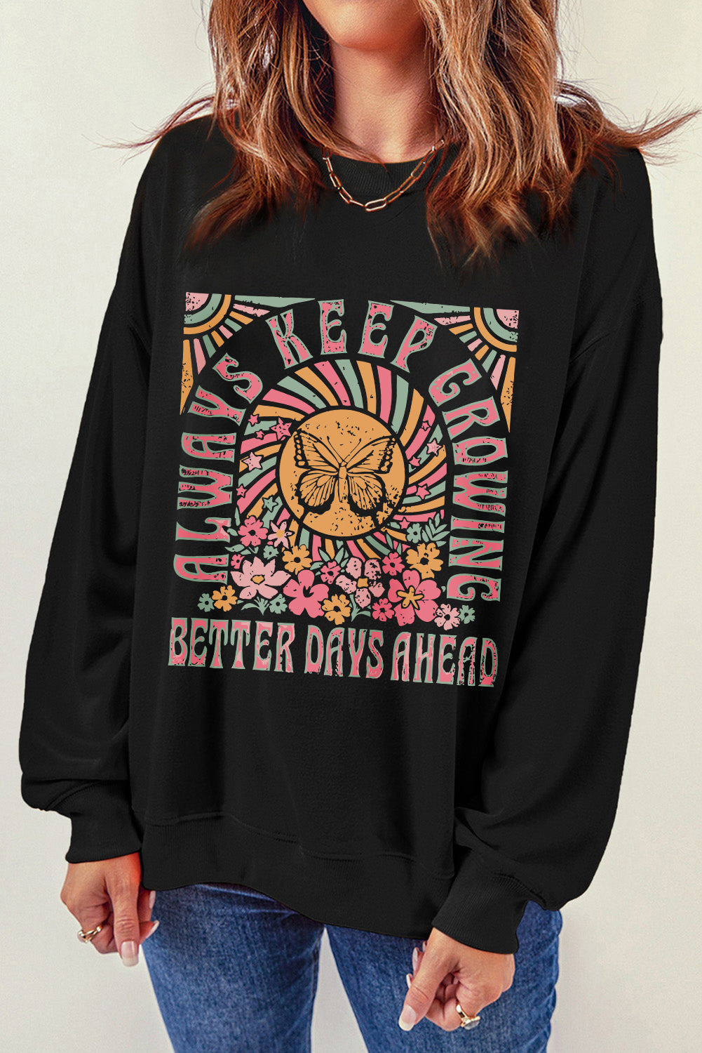 Black crewneck sweatshirt with butterfly and floral graphic and text.