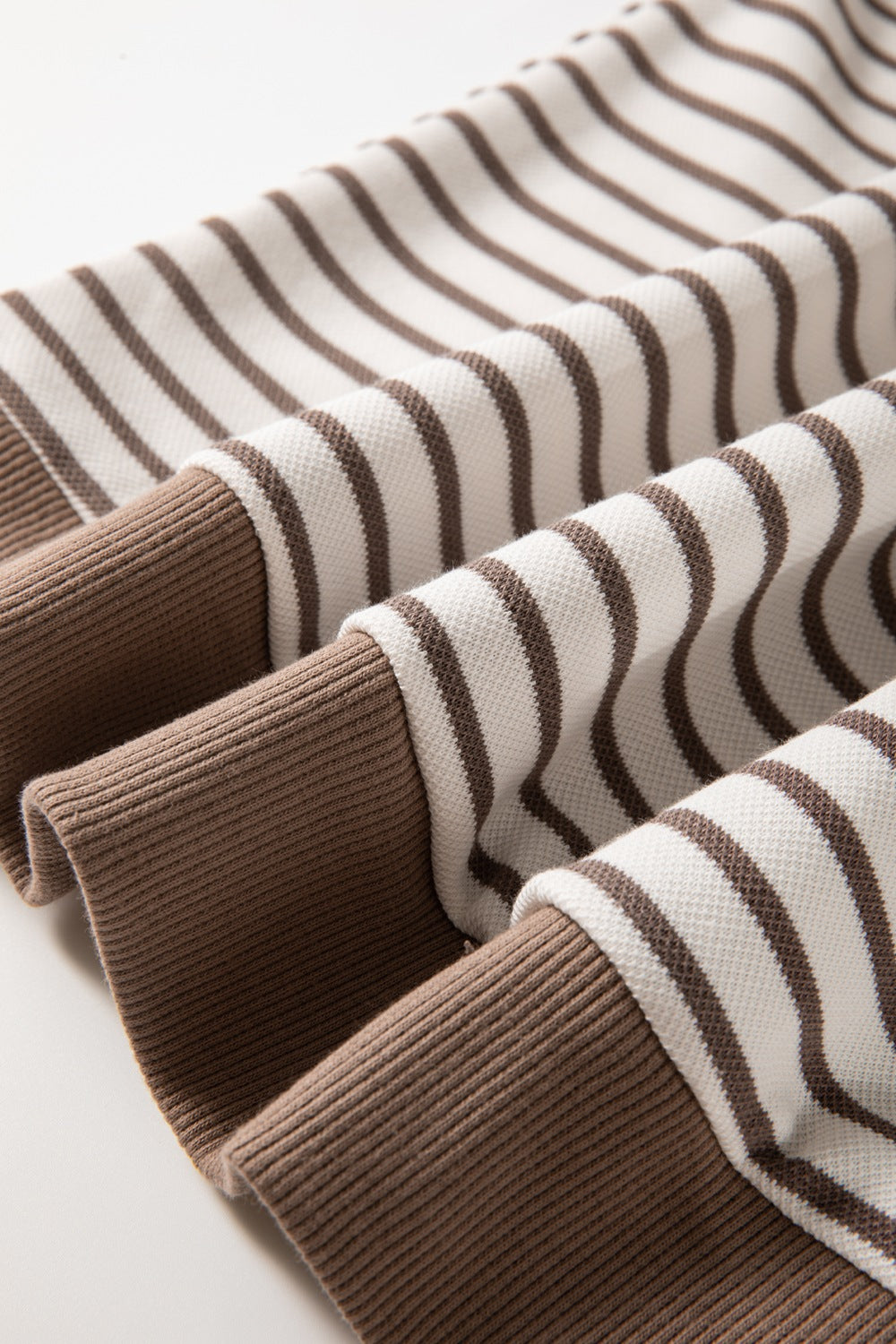 Brown and white striped tee with contrast brown ribbed cuffs and hem.
