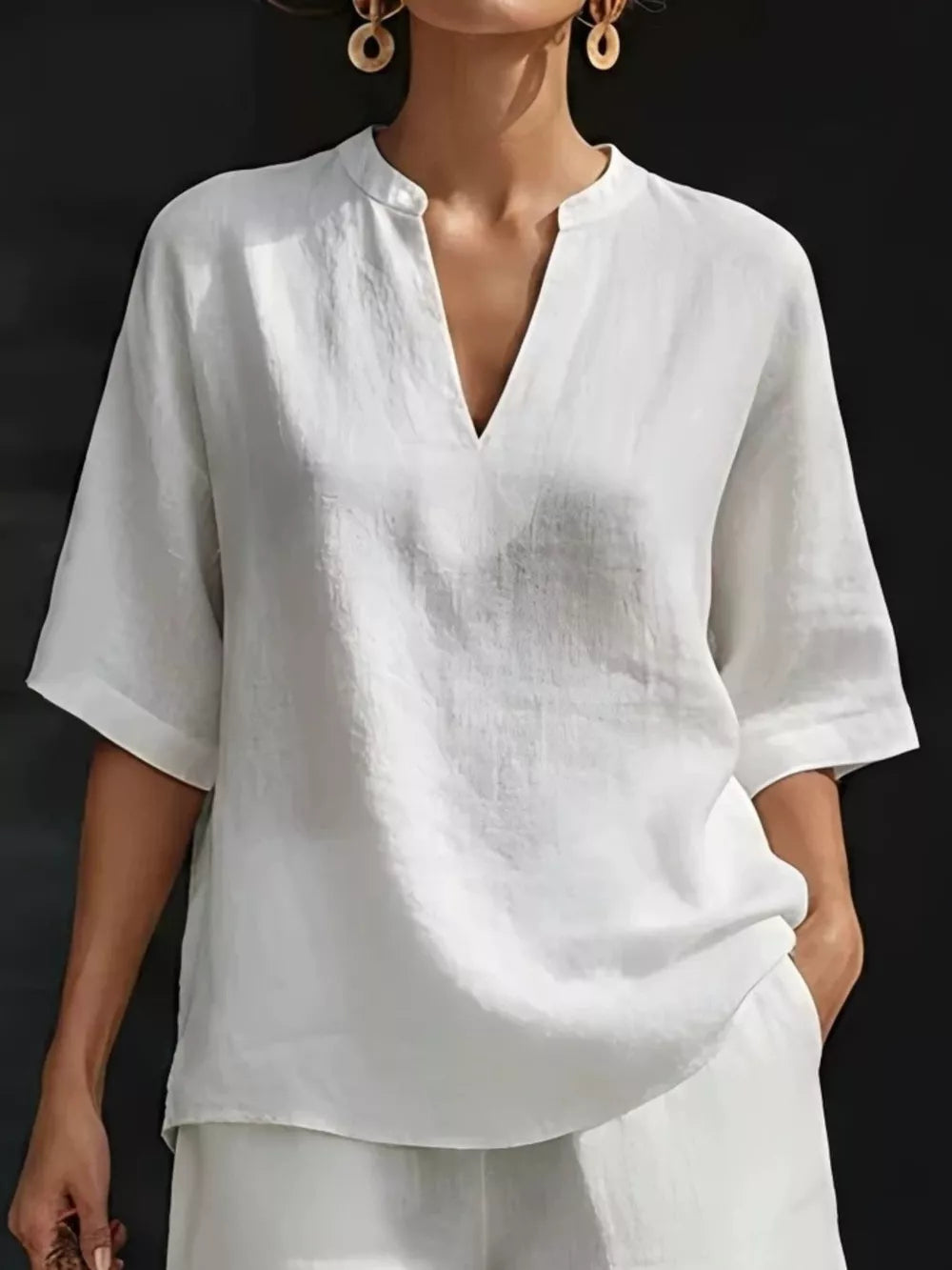 White oversized linen-blend top with V-neck and short sleeves, part of a two-piece set.