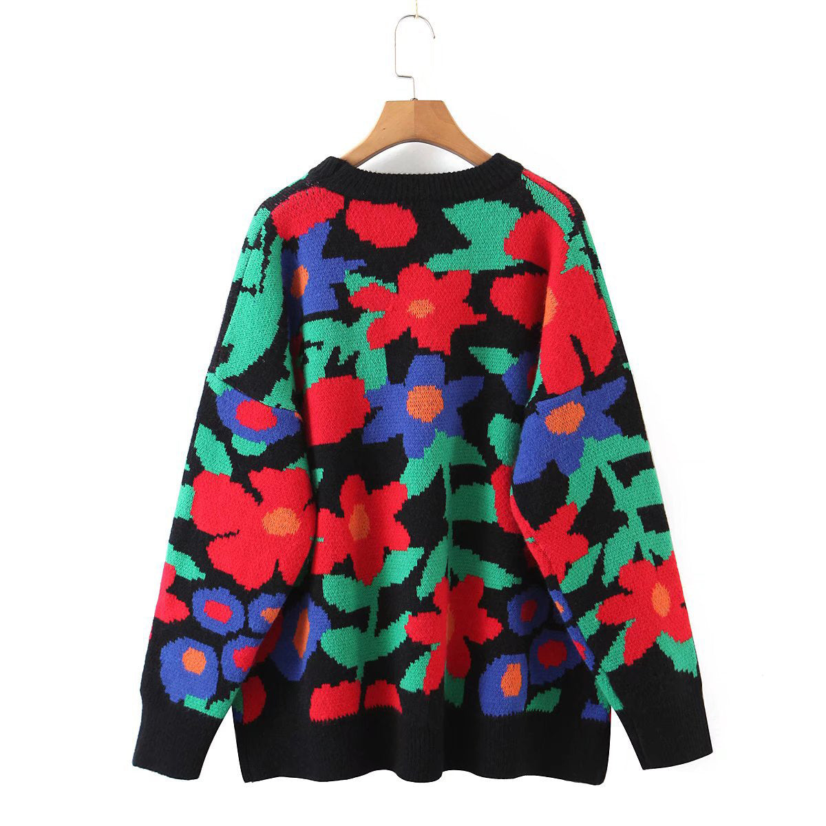 Black acrylic crewneck sweater with a bold floral intarsia pattern in red, blue, and green.