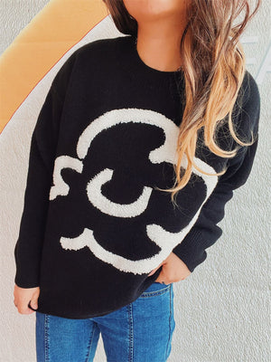Black acrylic sweater with white cloud intarsia pattern, crew neck, long sleeves.