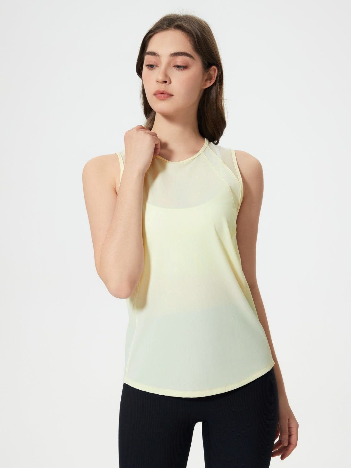 Yellow mesh-back performance tank top with sheer shoulder panels and a rounded hem.