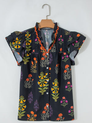 Black floral print cotton maternity shirt with V-neck, ruffled sleeves, and orange beaded trim.