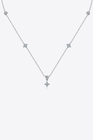 Silver diamond cluster necklace with delicate chain and four-petal flower charms.